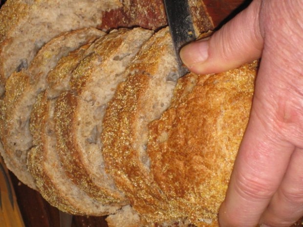 Dad slicing some bakery fresh wheat ciabatta